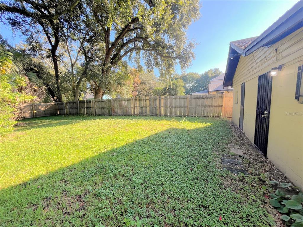 1235 Cypress Street, Unit 1/2 Orlando, FL 32805 - Photo 18 of 19 a view of a swimming pool with an outdoor space and seating area