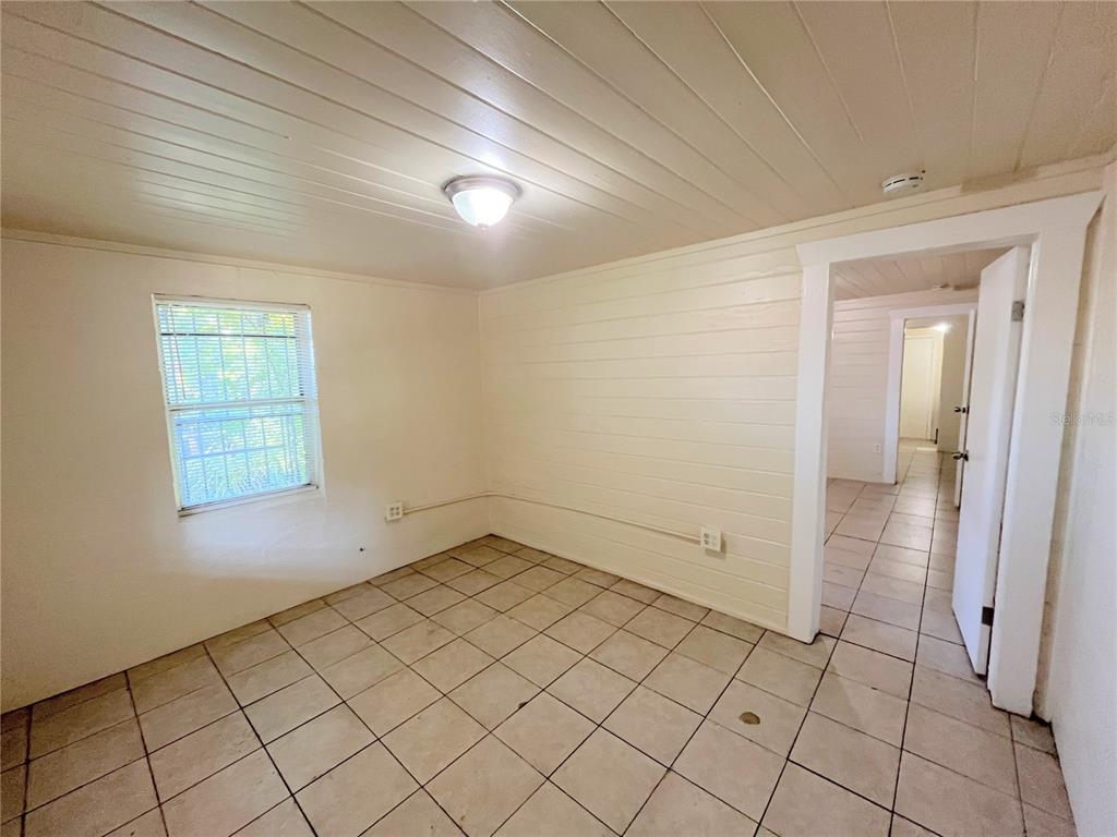 1235 Cypress Street, Unit 1/2 Orlando, FL 32805 - Photo 4 of 19 an empty room with windows