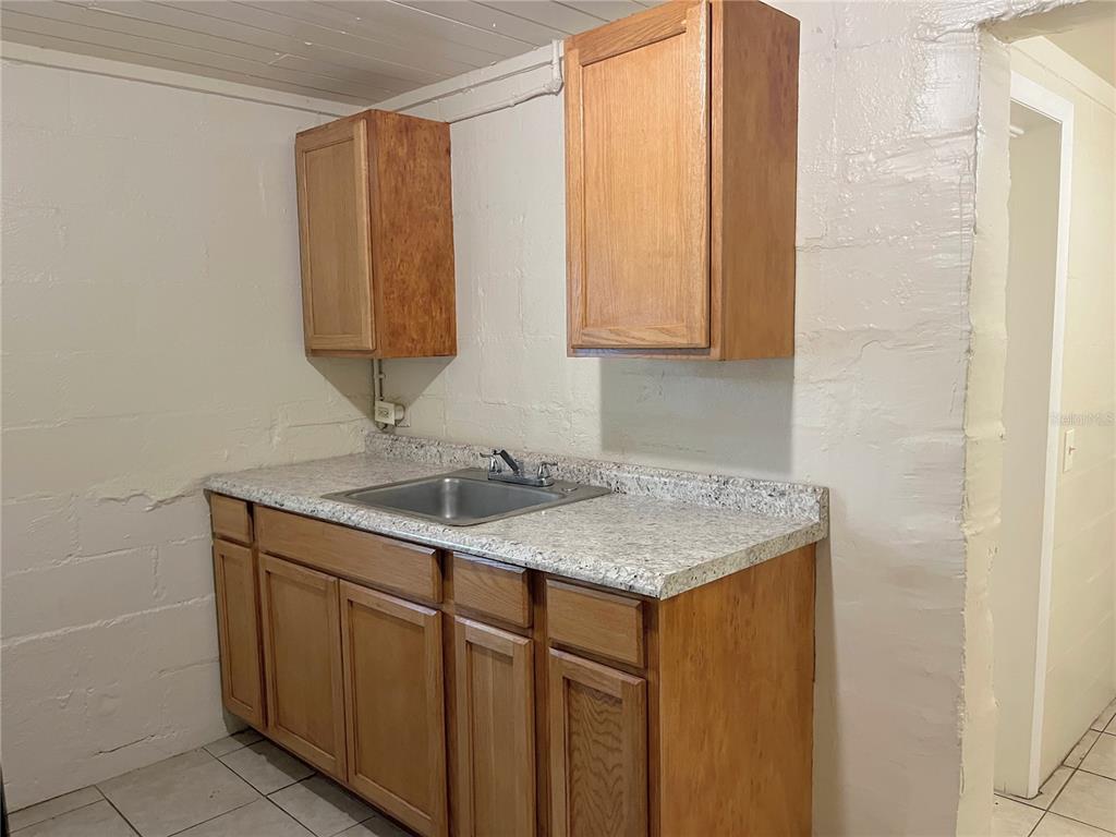 1235 Cypress Street, Unit 1/2 Orlando, FL 32805 - Photo 7 of 19 a bathroom with a sink and a mirror