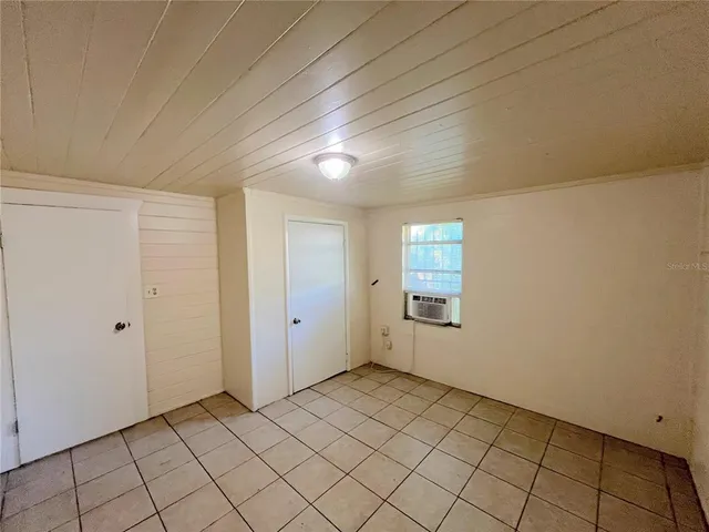 a view of an empty room with closet