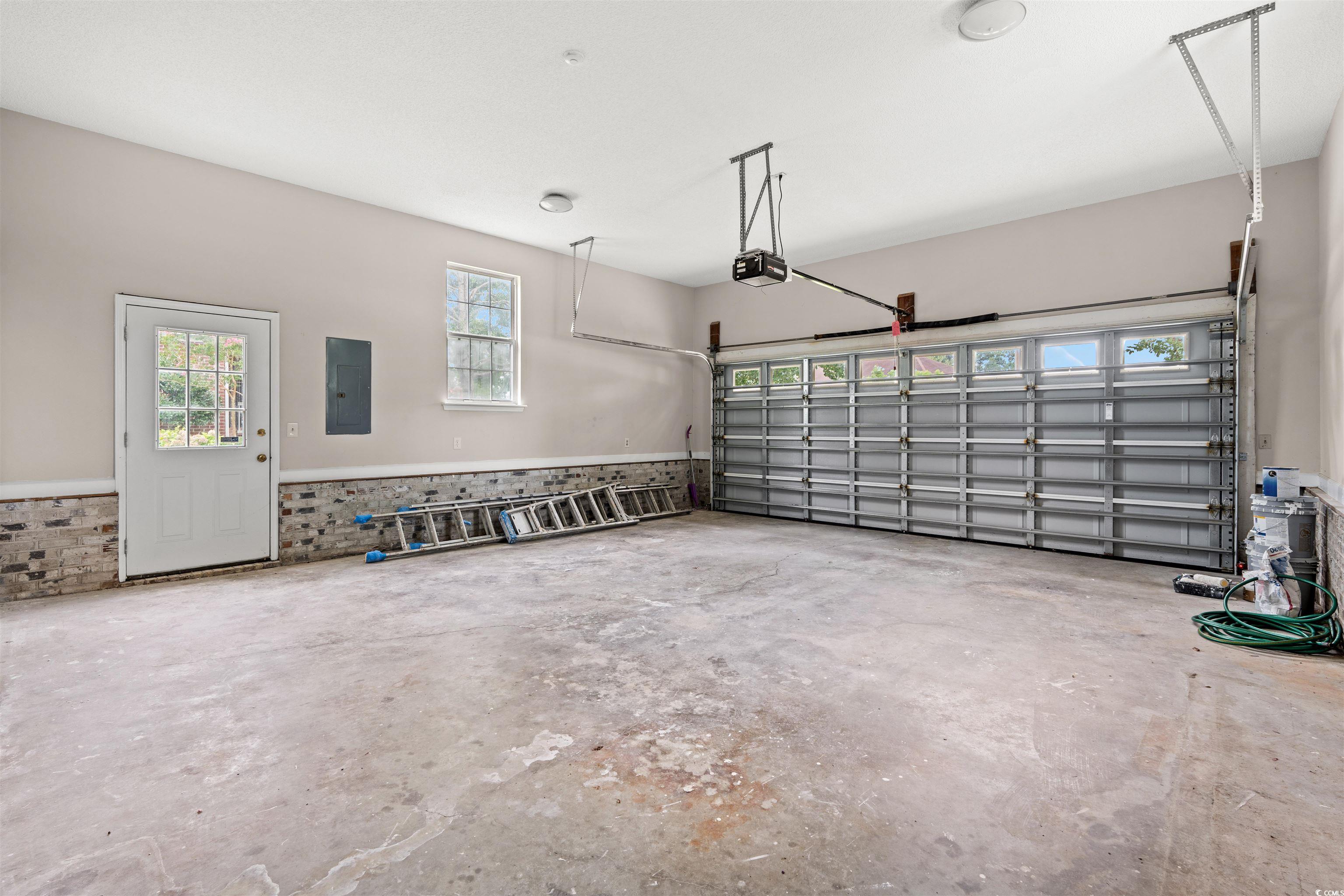 210 Ashley River Road Myrtle Beach, SC 29588 - Photo 33 of 39 Garage with electric panel and a garage door opene