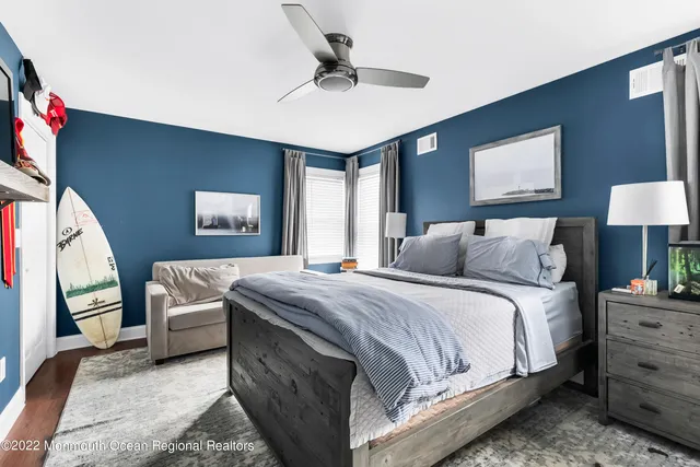 a bedroom with a large bed and a chandelier