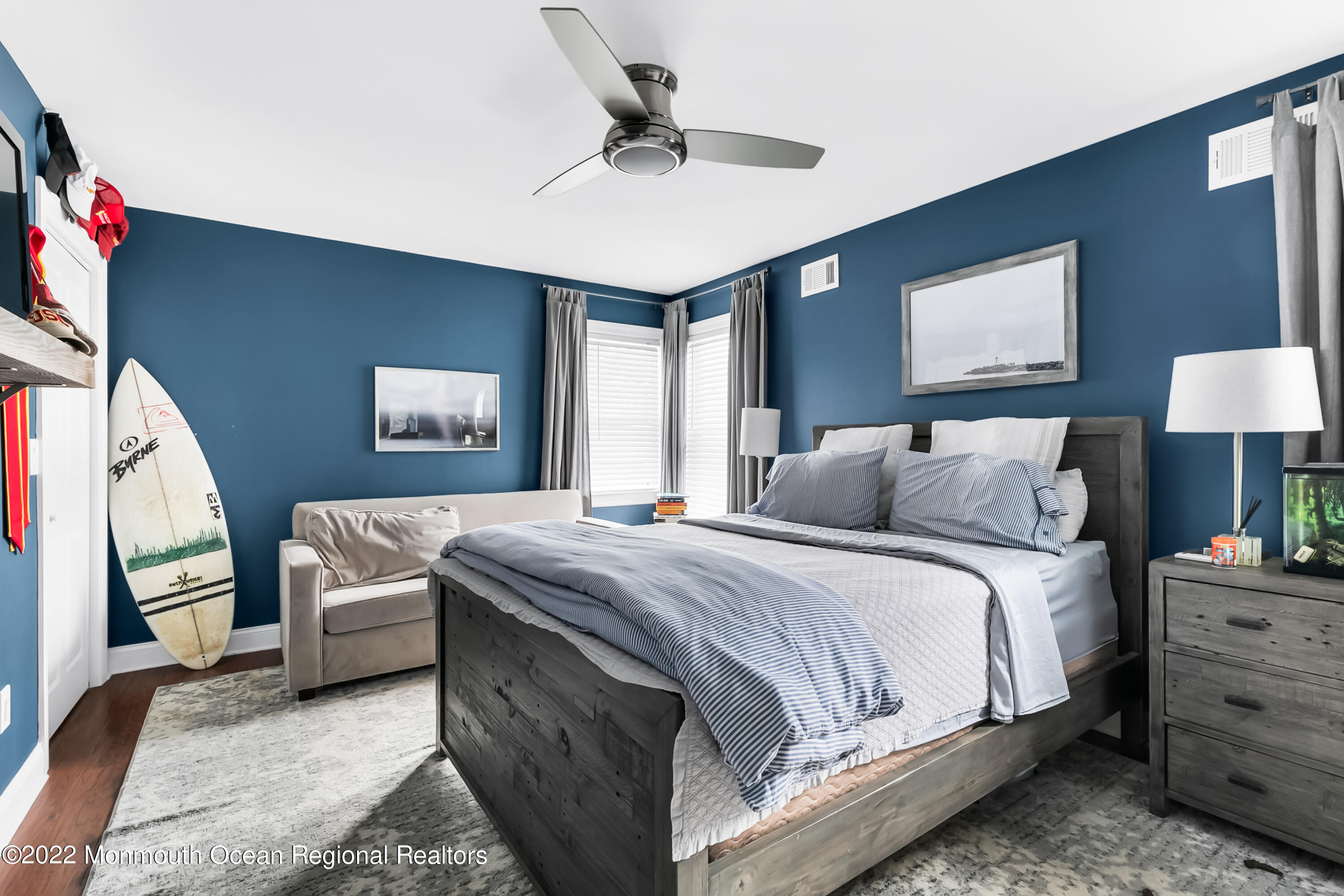 12 Captains Court Manasquan, NJ 08736 - Photo 13 of 30 a bedroom with a large bed and a chandelier