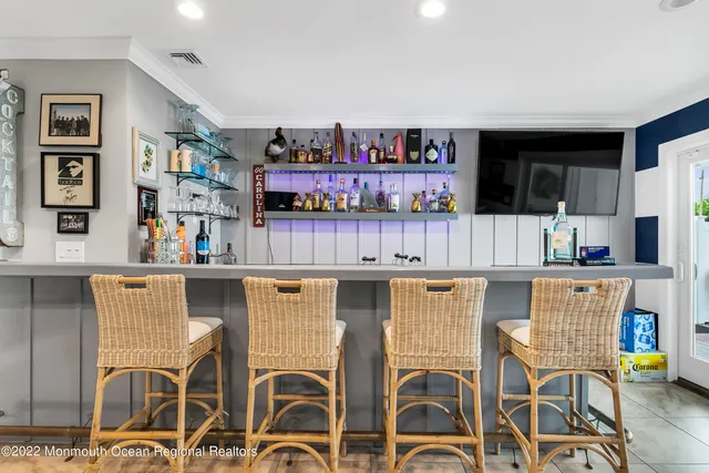 a kitchen with stainless steel appliances kitchen island granite countertop a table chairs and a refrigerator