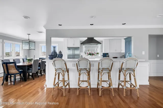 a dinning room filled with furniture and wooden floor