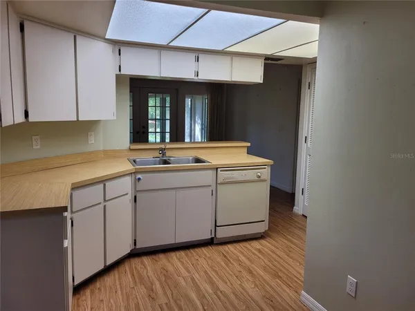 a kitchen with a sink cabinets and window