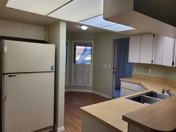 a kitchen with a refrigerator and a sink
