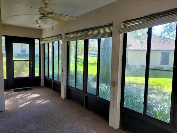 a view of an empty room with windows