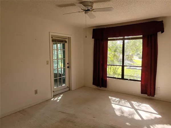 an empty room with windows and closet