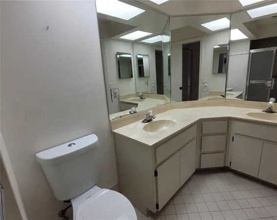 a bathroom with a sink toilet and mirror