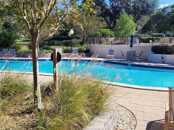 a view of house with swimming pool and furniture