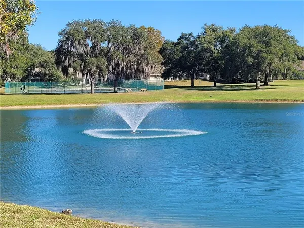 a view of a swimming pool with an outdoor seating and a yard