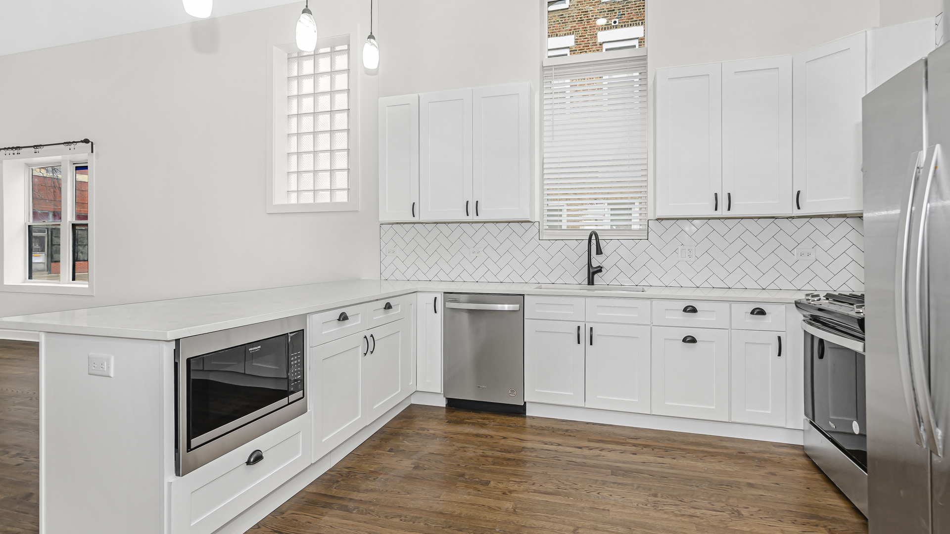 1925 South Racine Avenue, Unit 1F Chicago, IL 60608 - Photo 5 of 16 a kitchen with white cabinets stainless steel appliances and sink