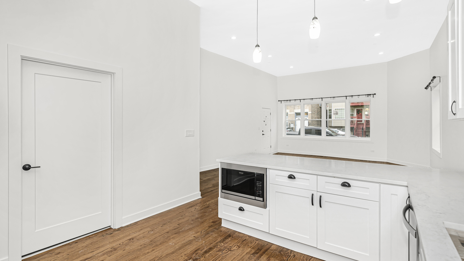1925 South Racine Avenue, Unit 1F Chicago, IL 60608 - Photo 6 of 16 a hallway with white cabinets and white appliances
