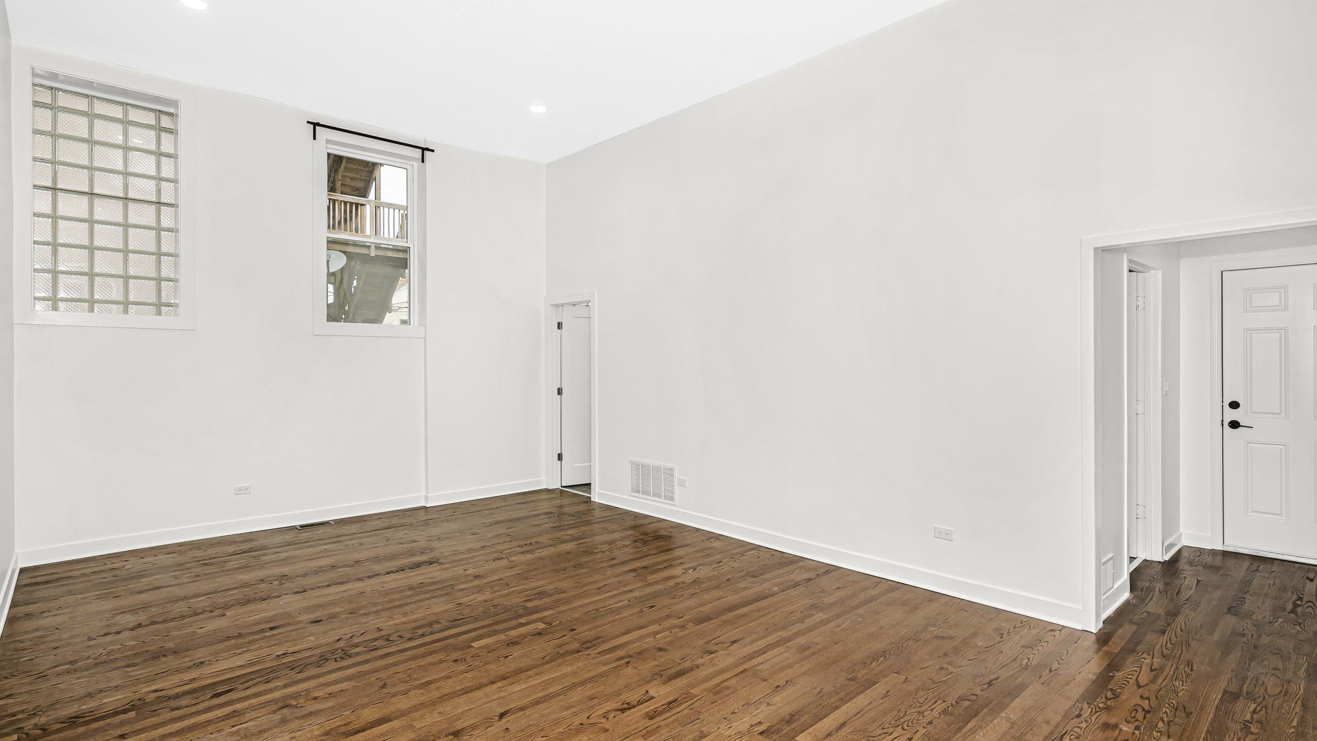 1925 South Racine Avenue, Unit 1F Chicago, IL 60608 - Photo 8 of 16 an empty room with wooden floor and windows