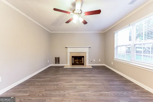 wooden floor fireplace and windows in a room