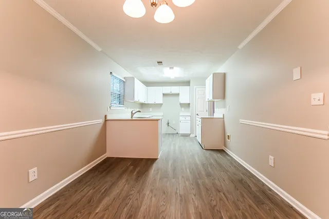 a view of a kitchen with wooden floor