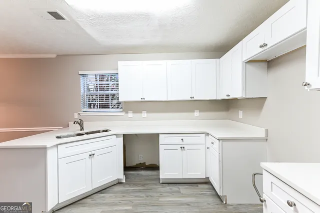 a kitchen with a sink cabinets and window