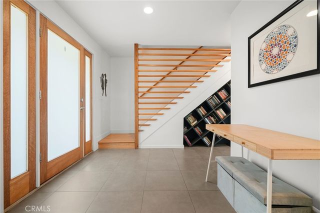 a view of a bedroom with a bed and wooden floor