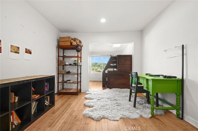 a bathroom with a bathtub shower sink vanity mirror and toilet
