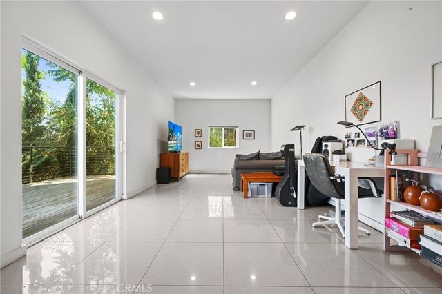 a view of a balcony with wooden stairs and potted plants
