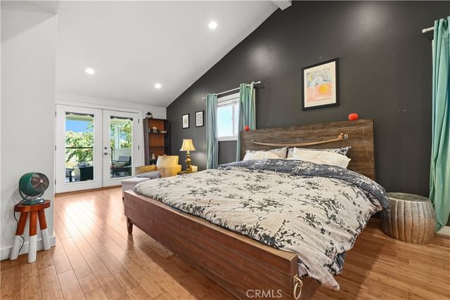 a bed sitting in a spacious bedroom next to a window