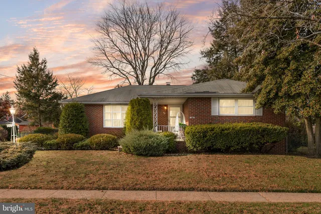 a front view of a house with a yard and outdoor seating