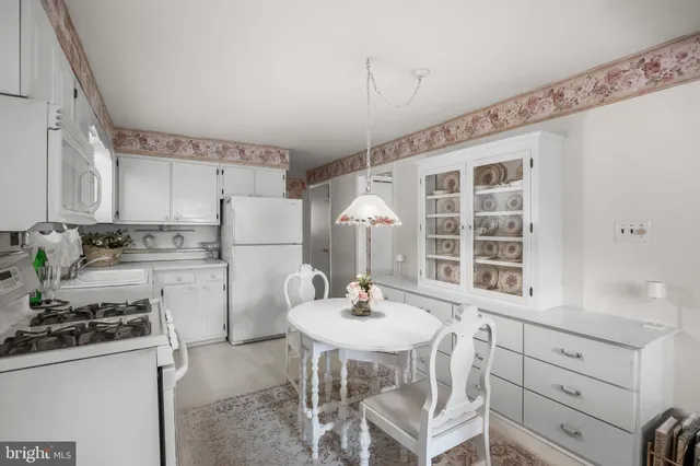 a kitchen with a sink stove and white cabinets