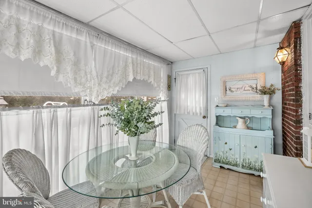a dining room with furniture and a chandelier