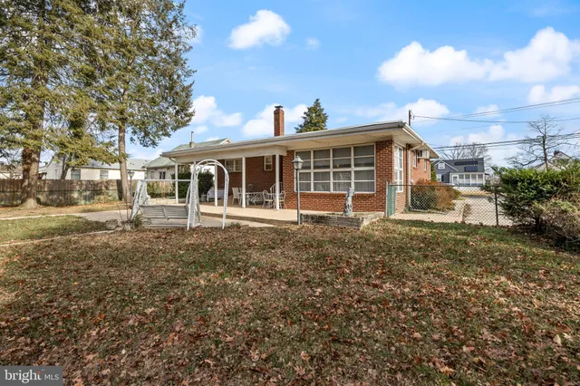 a view of a yard with plants and trees