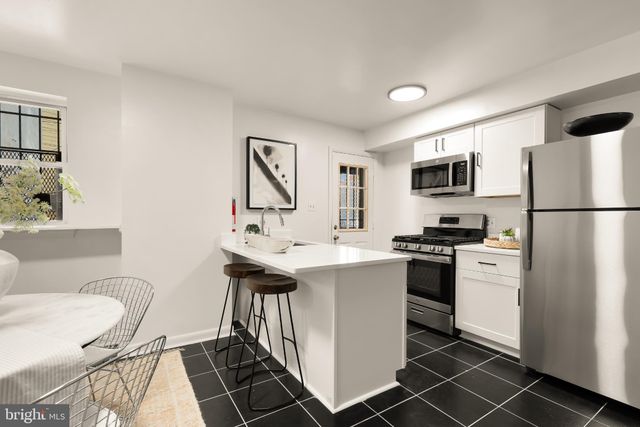 a kitchen with a sink appliances and cabinets
