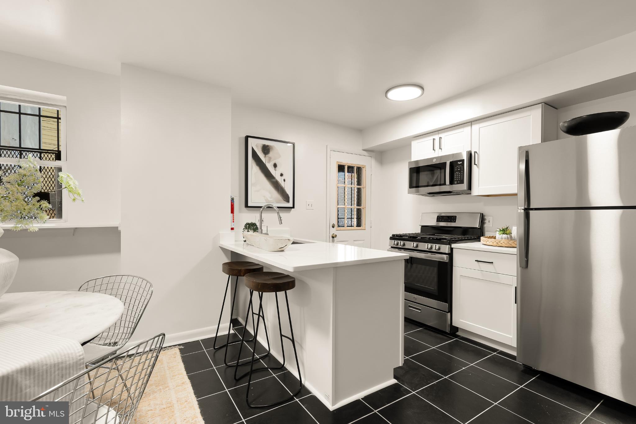 31 Florida Avenue Northeast Washington, DC 20002 - Photo 14 of 46 a kitchen with a sink appliances and cabinets