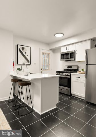 a kitchen with a stove a sink and a refrigerator