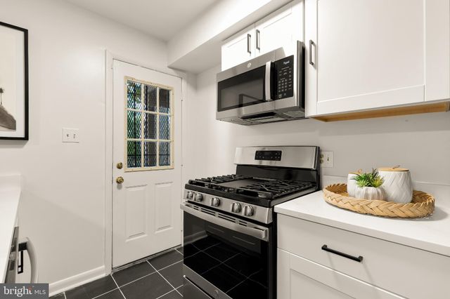a kitchen with stainless steel appliances a stove a microwave and cabinets
