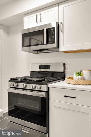 a kitchen with stainless steel appliances granite countertop a stove microwave and oven