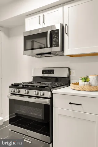 a kitchen with stainless steel appliances granite countertop a stove microwave and oven