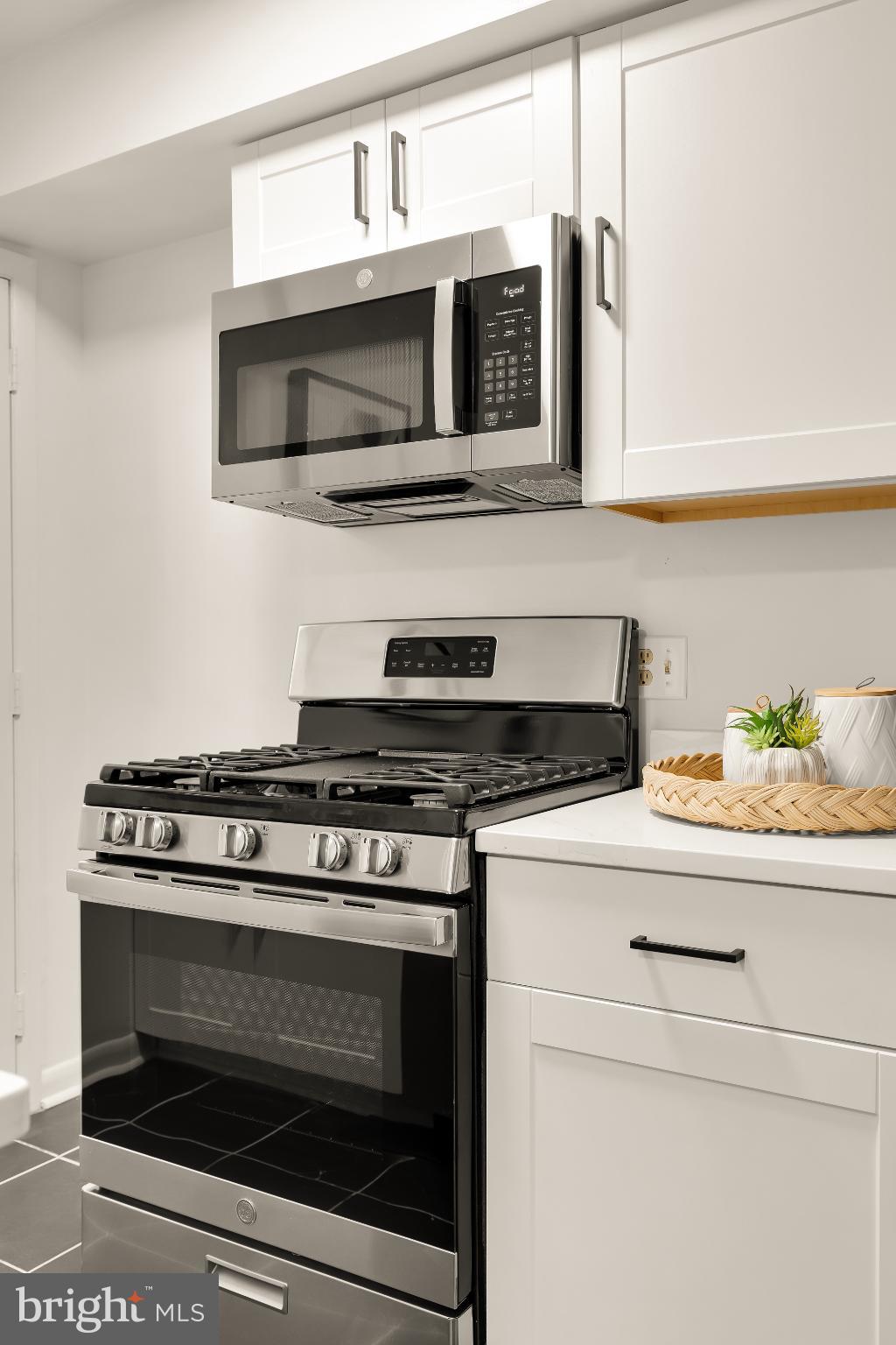 31 Florida Avenue Northeast Washington, DC 20002 - Photo 18 of 46 a kitchen with stainless steel appliances granite countertop a stove microwave and oven