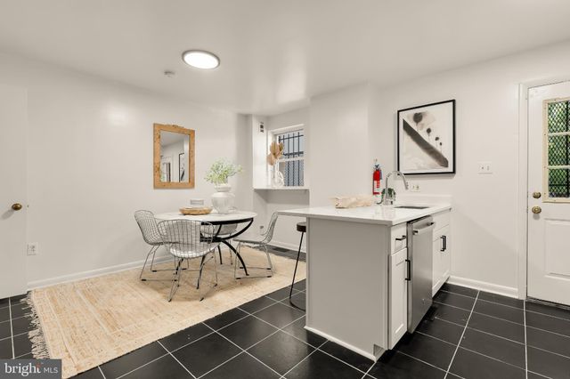 a view of kitchen with a sink dining table and chairs