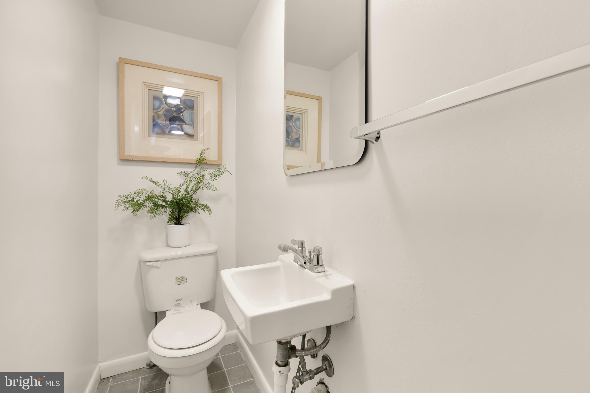 31 Florida Avenue Northeast Washington, DC 20002 - Photo 21 of 46 a bathroom with a toilet a sink and mirror