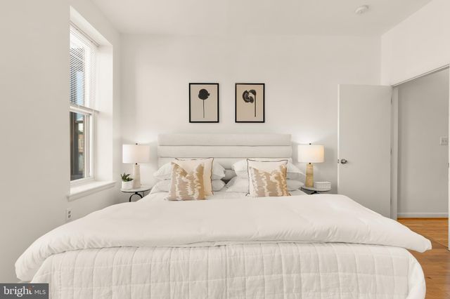 a bedroom with a large bed and a window