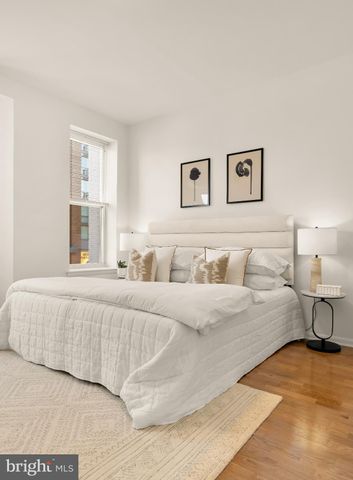 a bedroom with a large bed and a couch