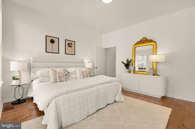 a bedroom with a bed and a dresser