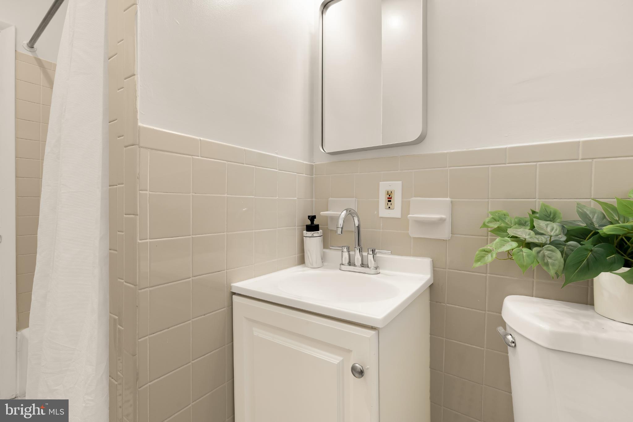 31 Florida Avenue Northeast Washington, DC 20002 - Photo 27 of 46 a bathroom with a sink a toilet and mirror
