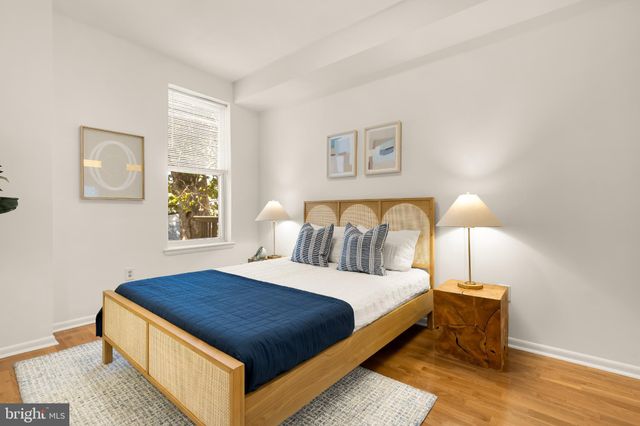 a bedroom with a bed and a night stand