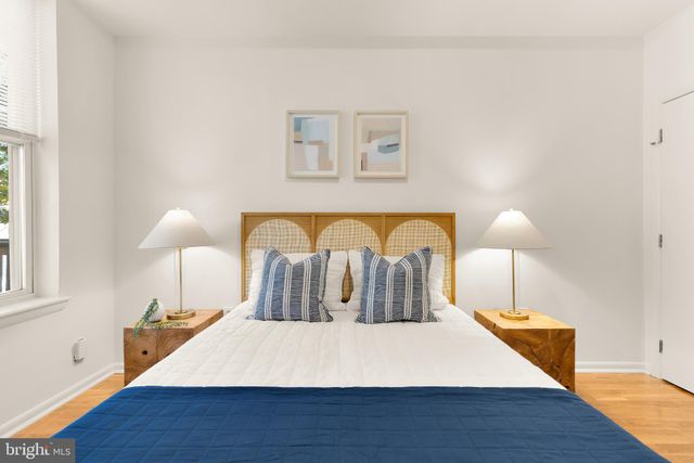 a bed room with a bed and a night stand