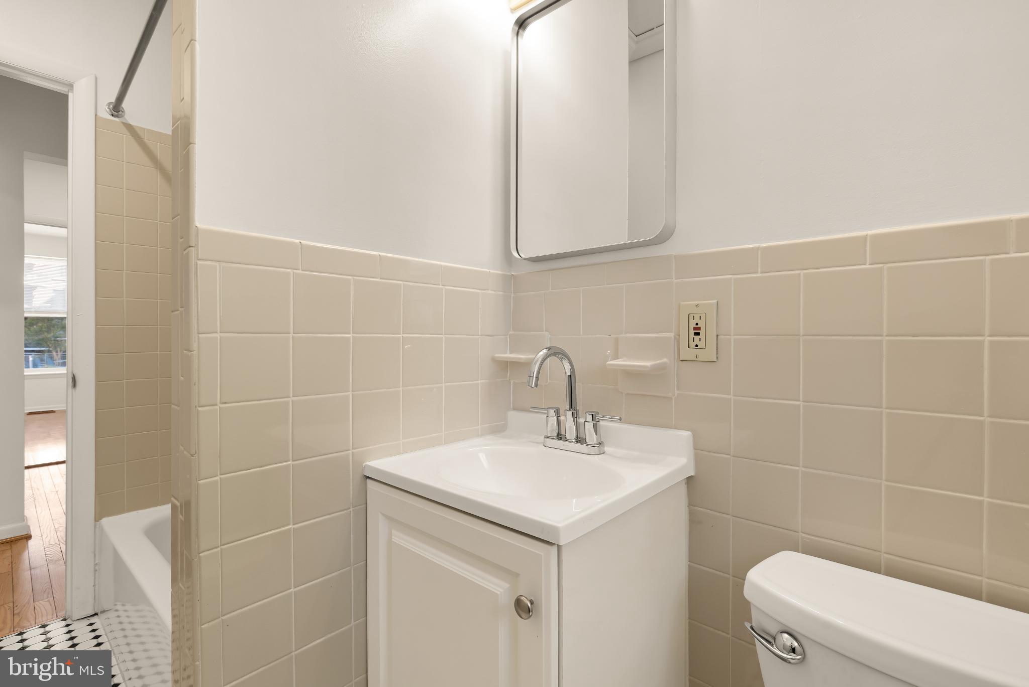 31 Florida Avenue Northeast Washington, DC 20002 - Photo 37 of 46 a bathroom with a sink a toilet and a mirror