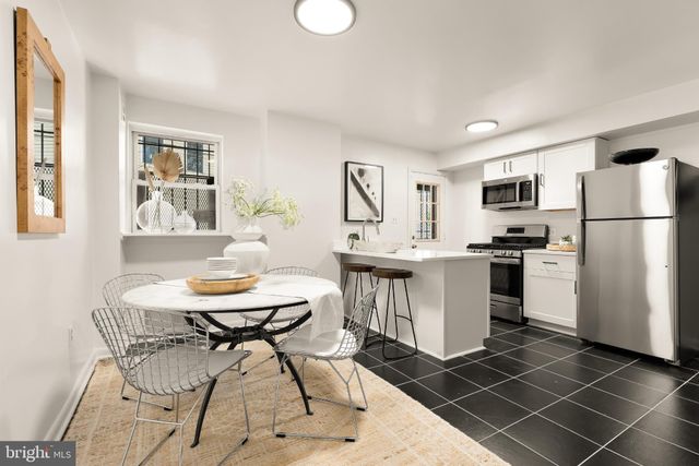 a kitchen with a sink cabinets and refrigerator