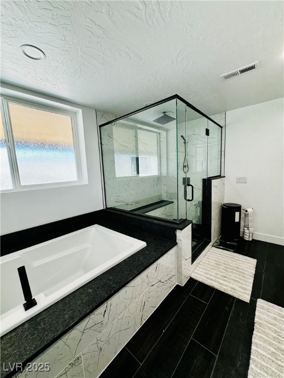 8946 Highway 93 Caliente, NV 89008 - Photo 18 of 40 Full bath with a marble finish shower, a garden tub, a textured ceiling, and vanity
