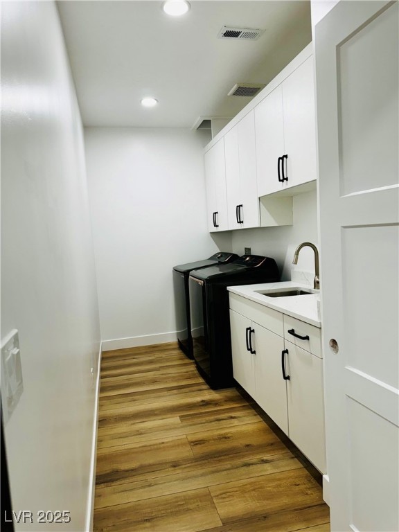 8946 Highway 93 Caliente, NV 89008 - Photo 23 of 40 Washroom with cabinet space, light wood-style flooring, recessed lighting, and independent washer and dryer