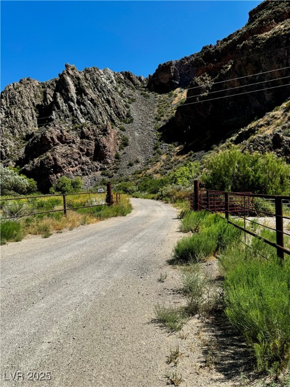 8946 Highway 93 Caliente, NV 89008 - Photo 3 of 40 View of dirt / gravel road featuring a mountain view and a view of rural / pastoral area